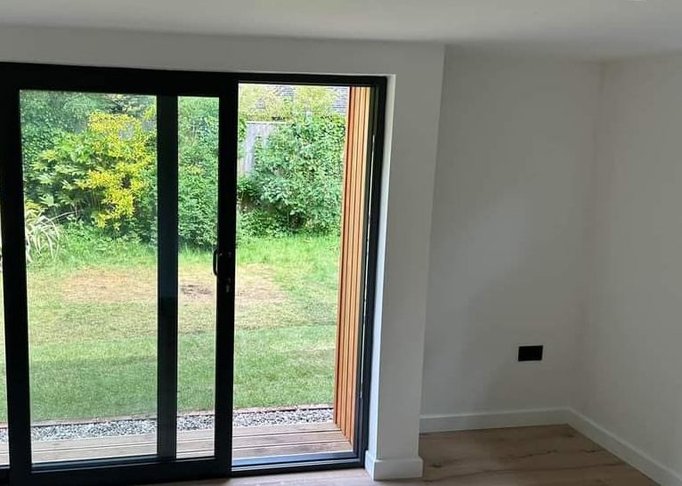 Expertly plastered walls in room with sliding doors
